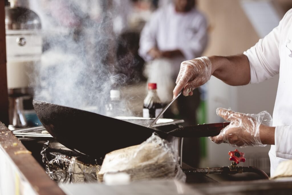 A closeup shot of a chef cooking with a blurred background